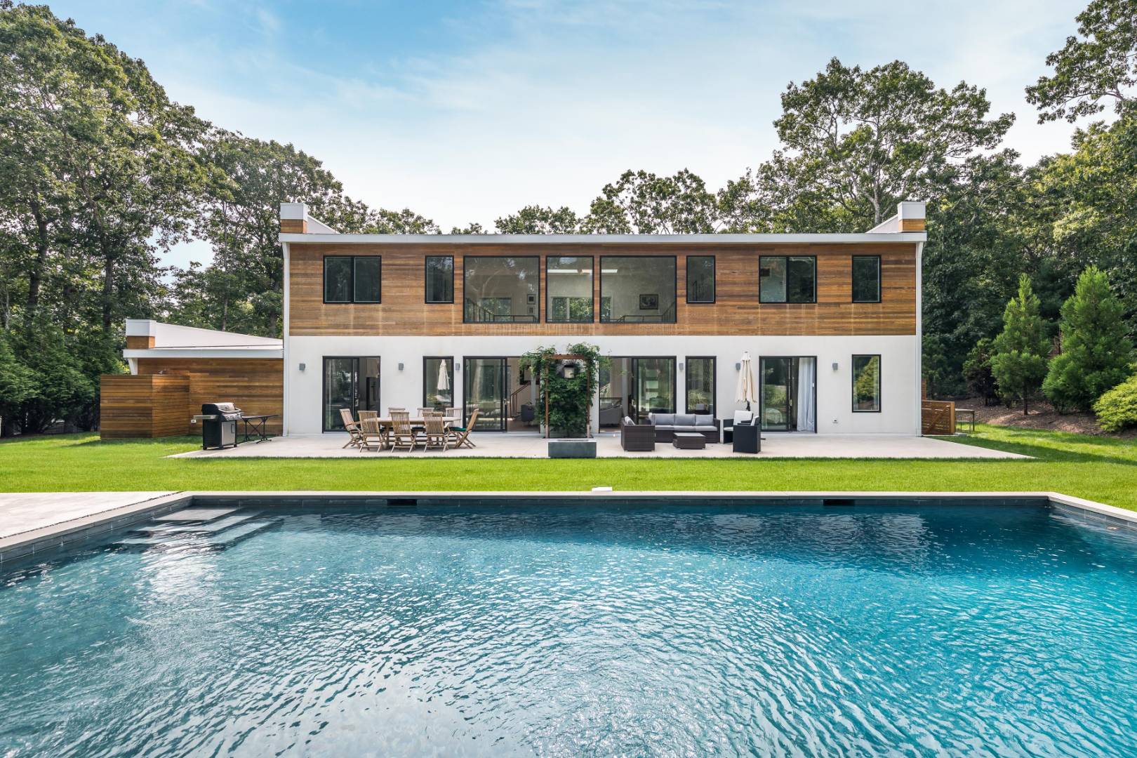 6 Landfall Circle East Hampton, NY 11937 - Photo 1 of 26 a view of a swimming pool with a yard and plants