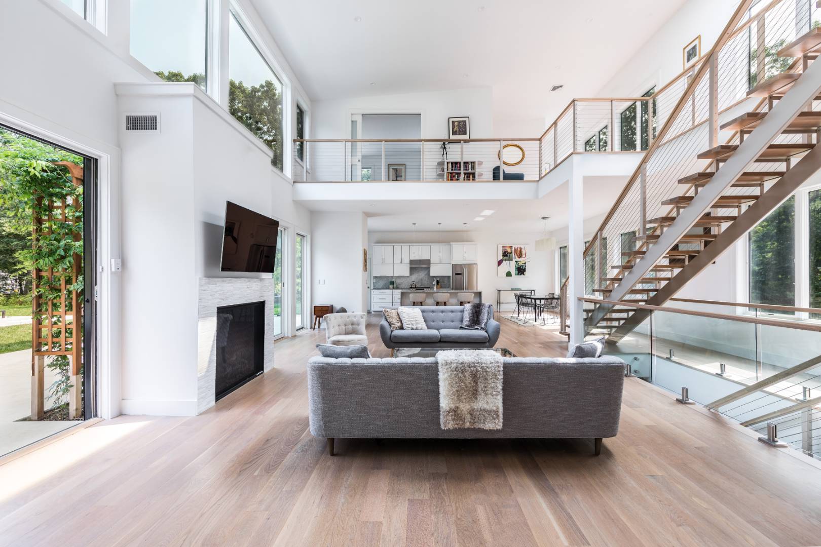 6 Landfall Circle East Hampton, NY 11937 - Photo 3 of 26 a living room with furniture a fireplace and a floor to ceiling window