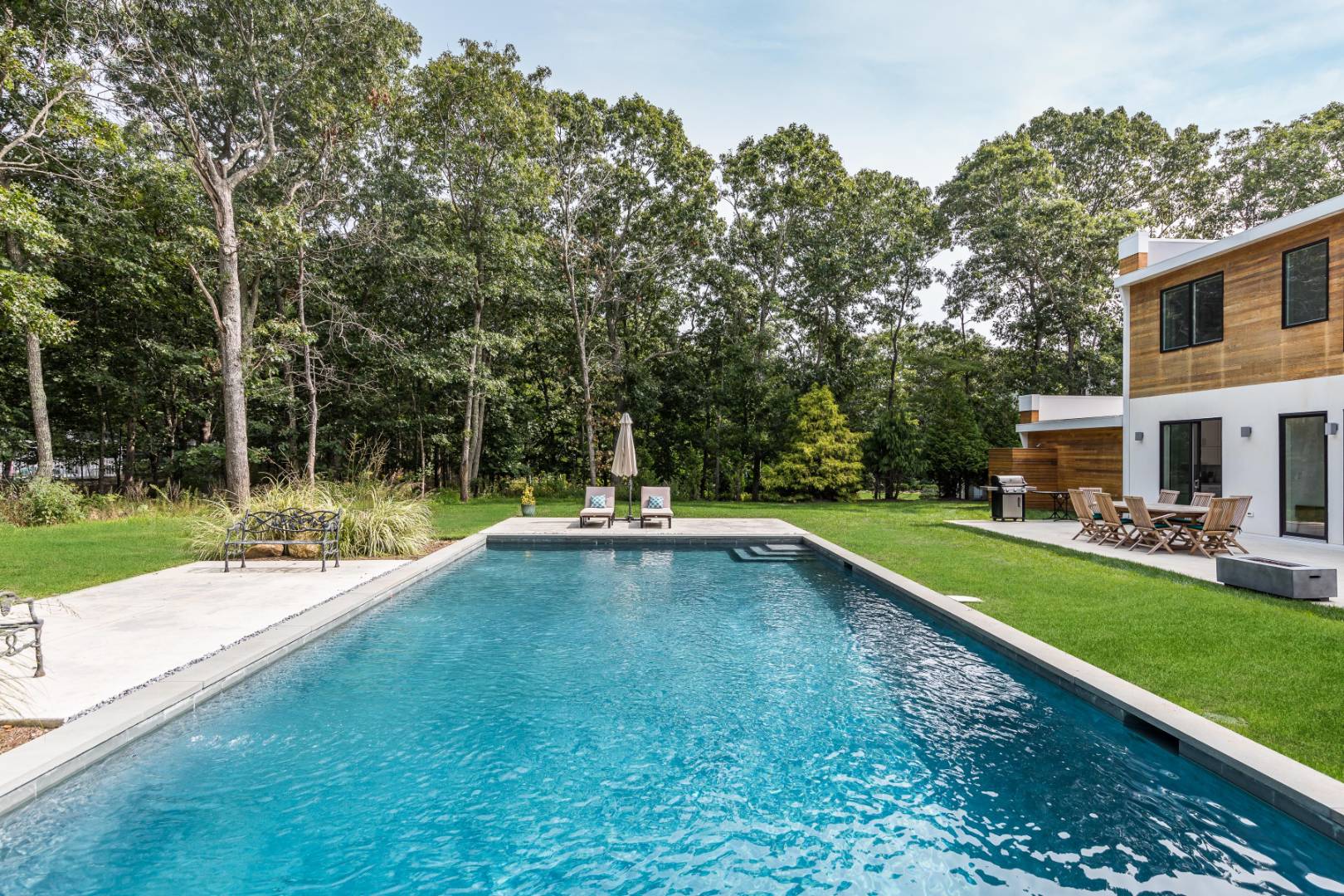 6 Landfall Circle East Hampton, NY 11937 - Photo 23 of 26 a view of pool with lawn chairs and large trees