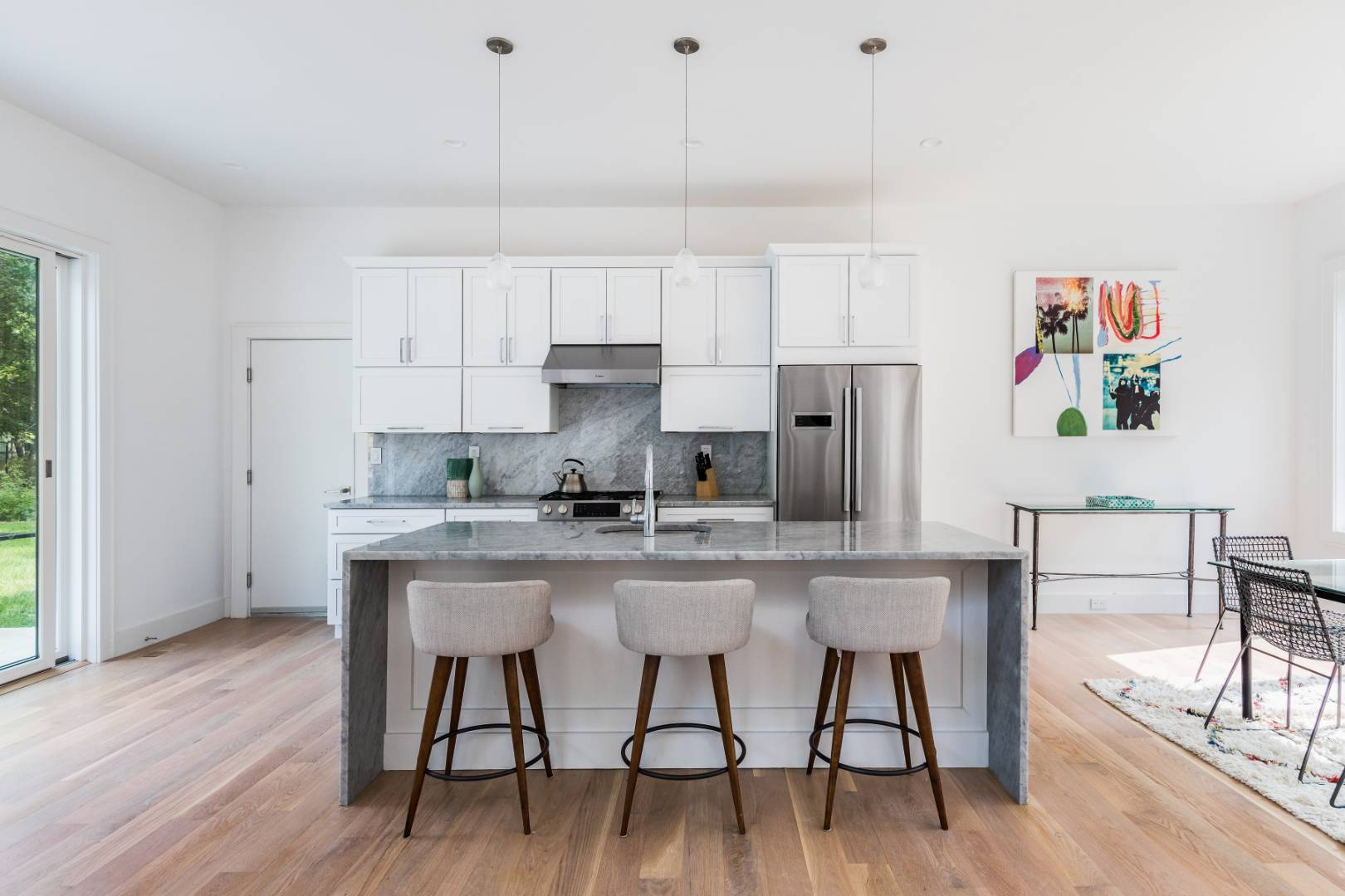 6 Landfall Circle East Hampton, NY 11937 - Photo 4 of 26 a kitchen with stainless steel appliances granite countertop a white cabinets and wooden floor