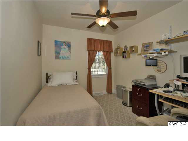 23 Stonefield Road Palmyra, VA 22963 - Photo 21 of 32 a bedroom with a bed and a chandelier