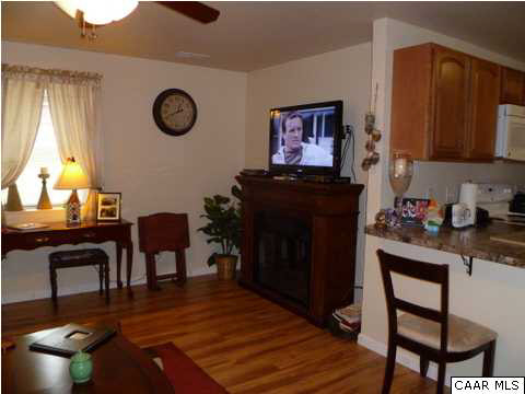 23 Stonefield Road Palmyra, VA 22963 - Photo 27 of 32 a living room with furniture a clock on wall and a window
