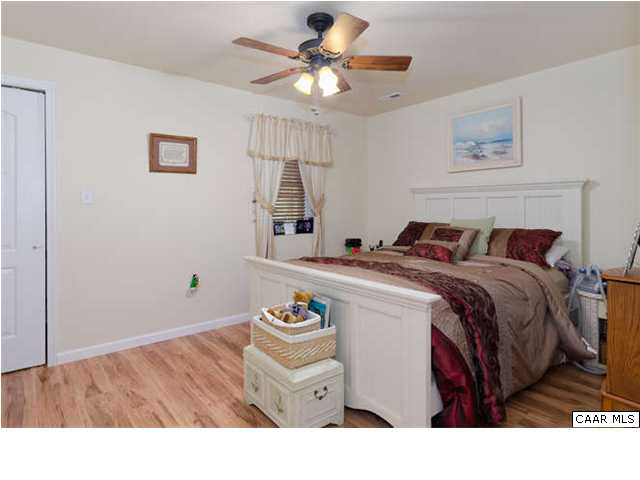23 Stonefield Road Palmyra, VA 22963 - Photo 28 of 32 a bedroom with a bed and a chandelier