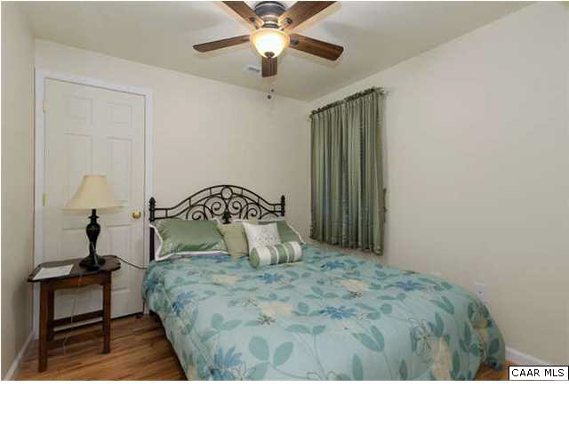 23 Stonefield Road Palmyra, VA 22963 - Photo 32 of 32 a bedroom with a bed and a chandelier