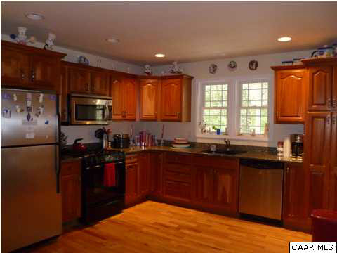 23 Stonefield Road Palmyra, VA 22963 - Photo 10 of 32 a kitchen with granite countertop stainless steel appliances a refrigerator sink and wooden cabinets