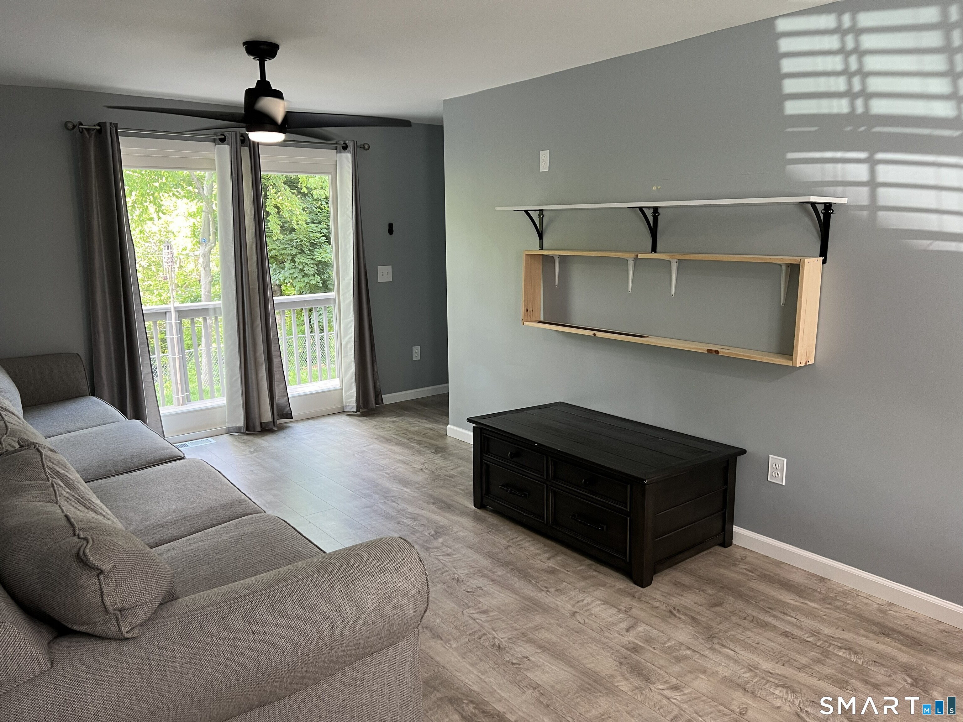82 Bingham Street Bristol, CT 06010 - Photo 9 of 40 a living room with furniture and a floor to ceiling window