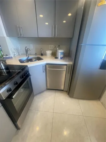 a kitchen with a sink a stove and cabinets