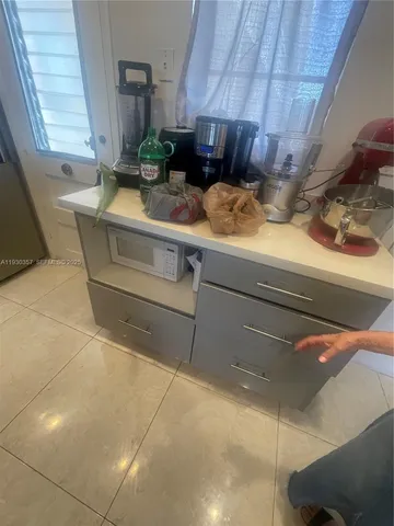 a kitchen with a sink appliances and cabinets