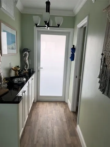 a kitchen with a sink and wooden floor