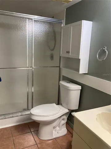 a white toilet sitting next to a bathroom sink
