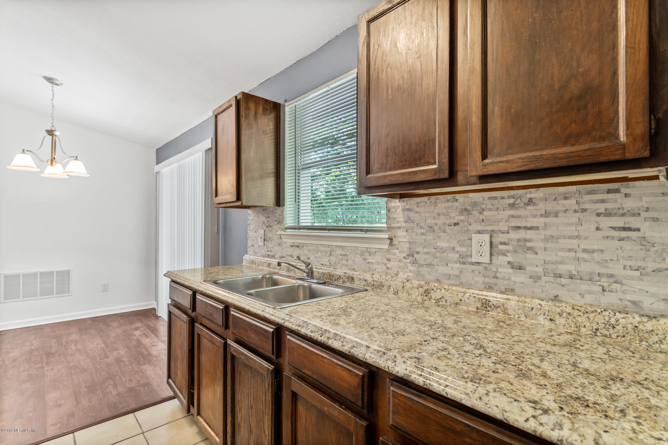 7163 Melvin Road Jacksonville, FL 32210 - Photo 14 of 33 a bathroom with a granite countertop sink and a mirror