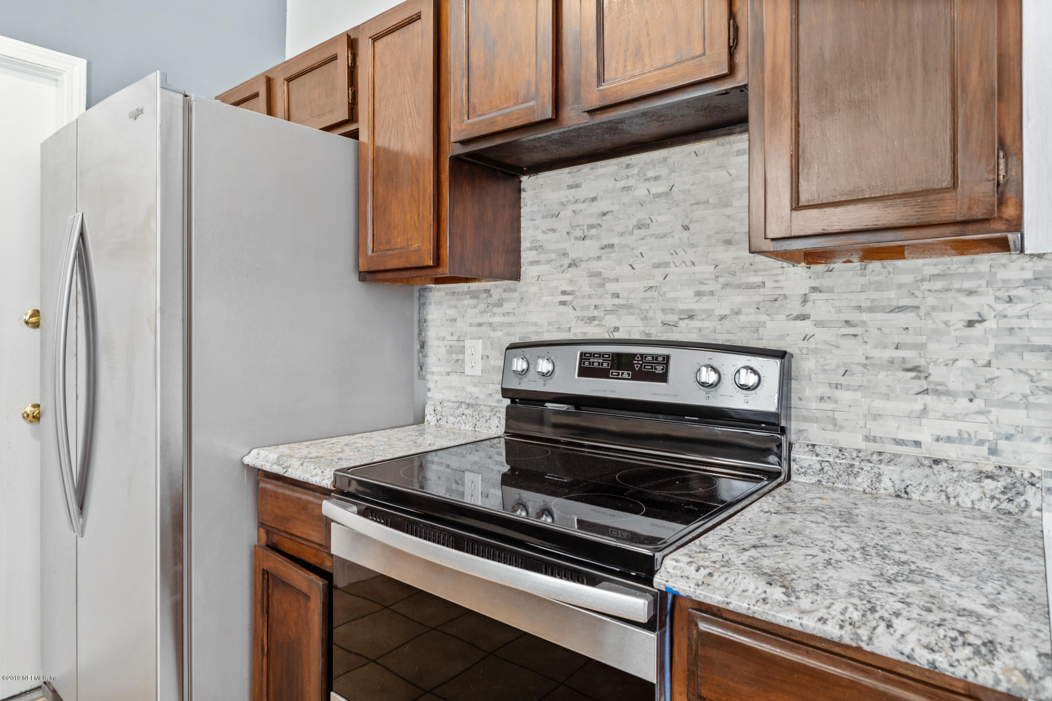 7163 Melvin Road Jacksonville, FL 32210 - Photo 16 of 33 a stove top oven sitting inside of a kitchen
