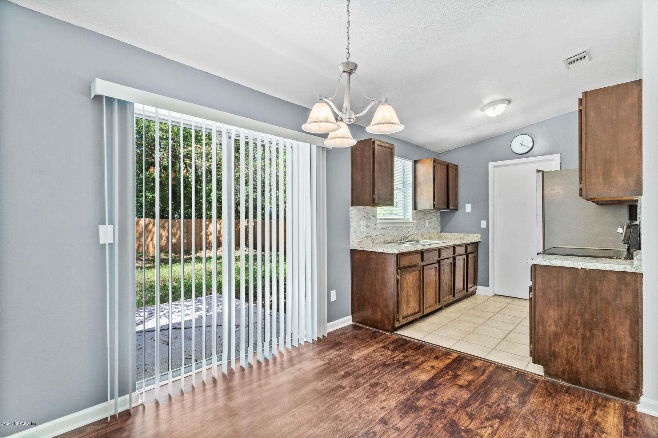 7163 Melvin Road Jacksonville, FL 32210 - Photo 18 of 33 a kitchen with stainless steel appliances granite countertop a stove and cabinets