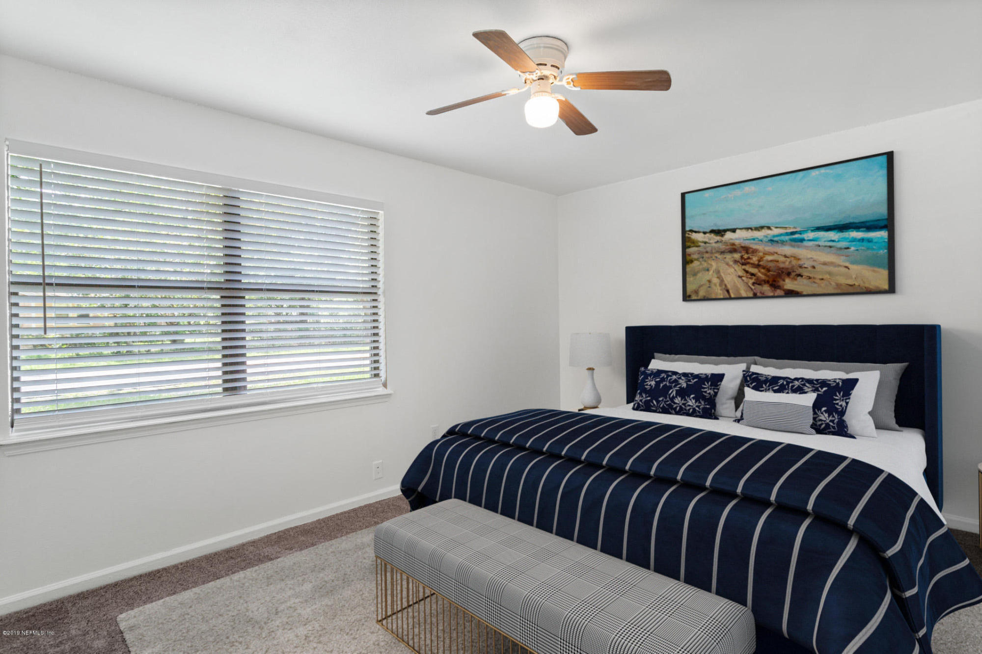 7163 Melvin Road Jacksonville, FL 32210 - Photo 19 of 33 a bedroom with a bed and a painting on the wall