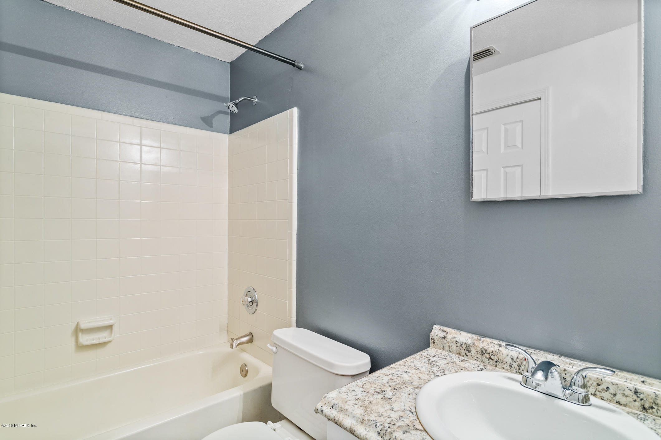 7163 Melvin Road Jacksonville, FL 32210 - Photo 22 of 33 a bathroom with a sink toilet and shower