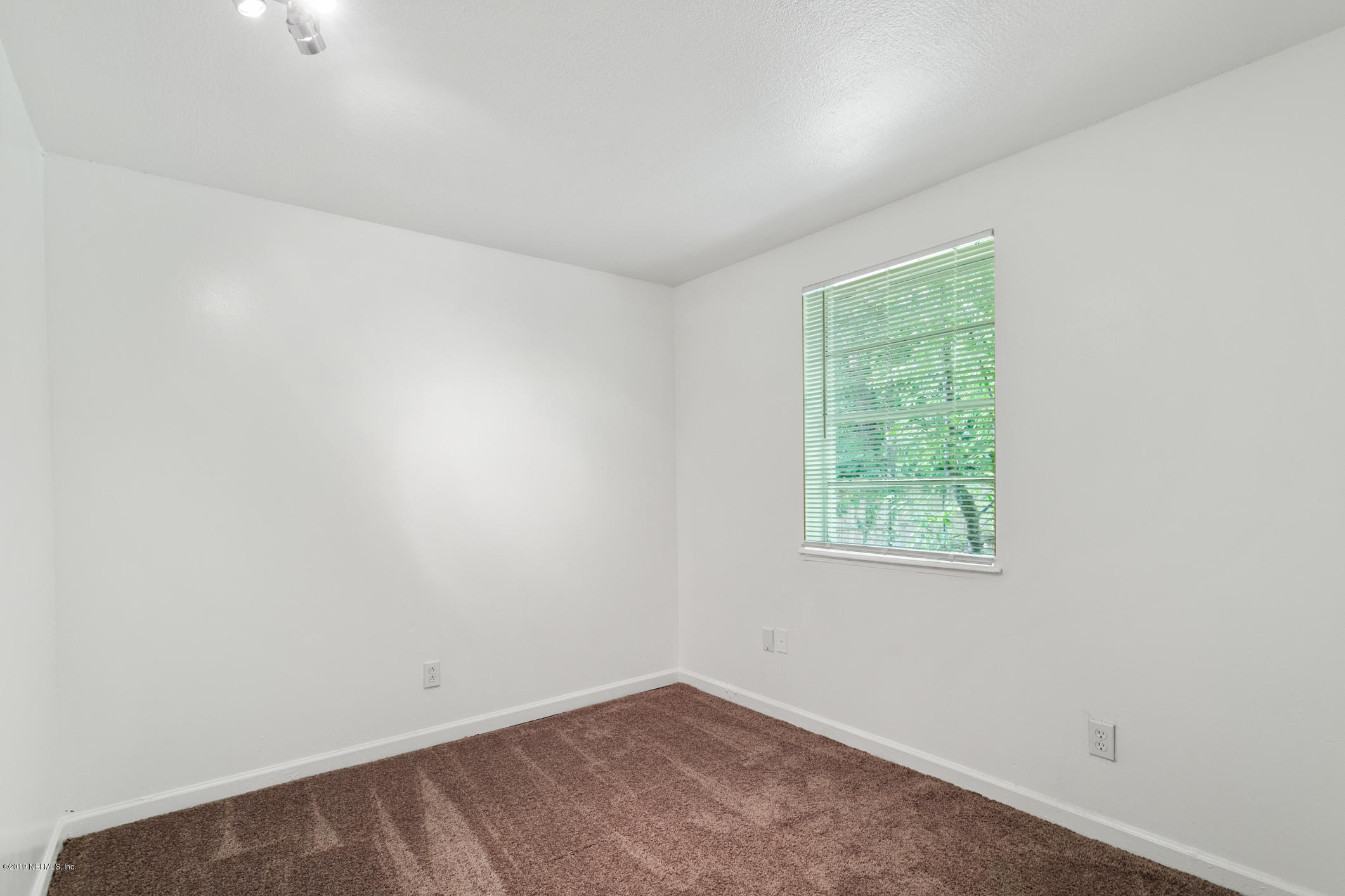 7163 Melvin Road Jacksonville, FL 32210 - Photo 25 of 33 an empty room with a window