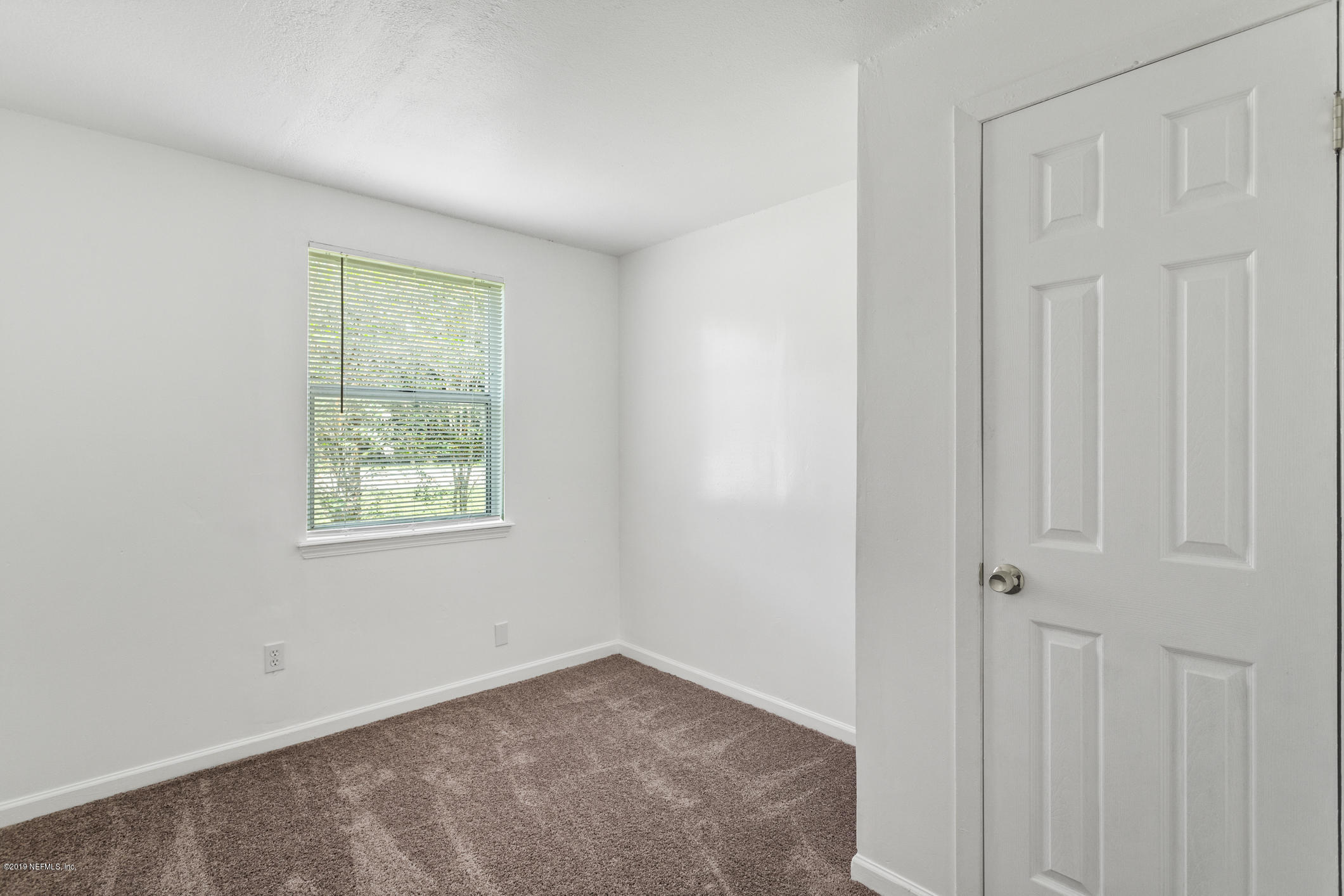 7163 Melvin Road Jacksonville, FL 32210 - Photo 26 of 33 an empty room with a window