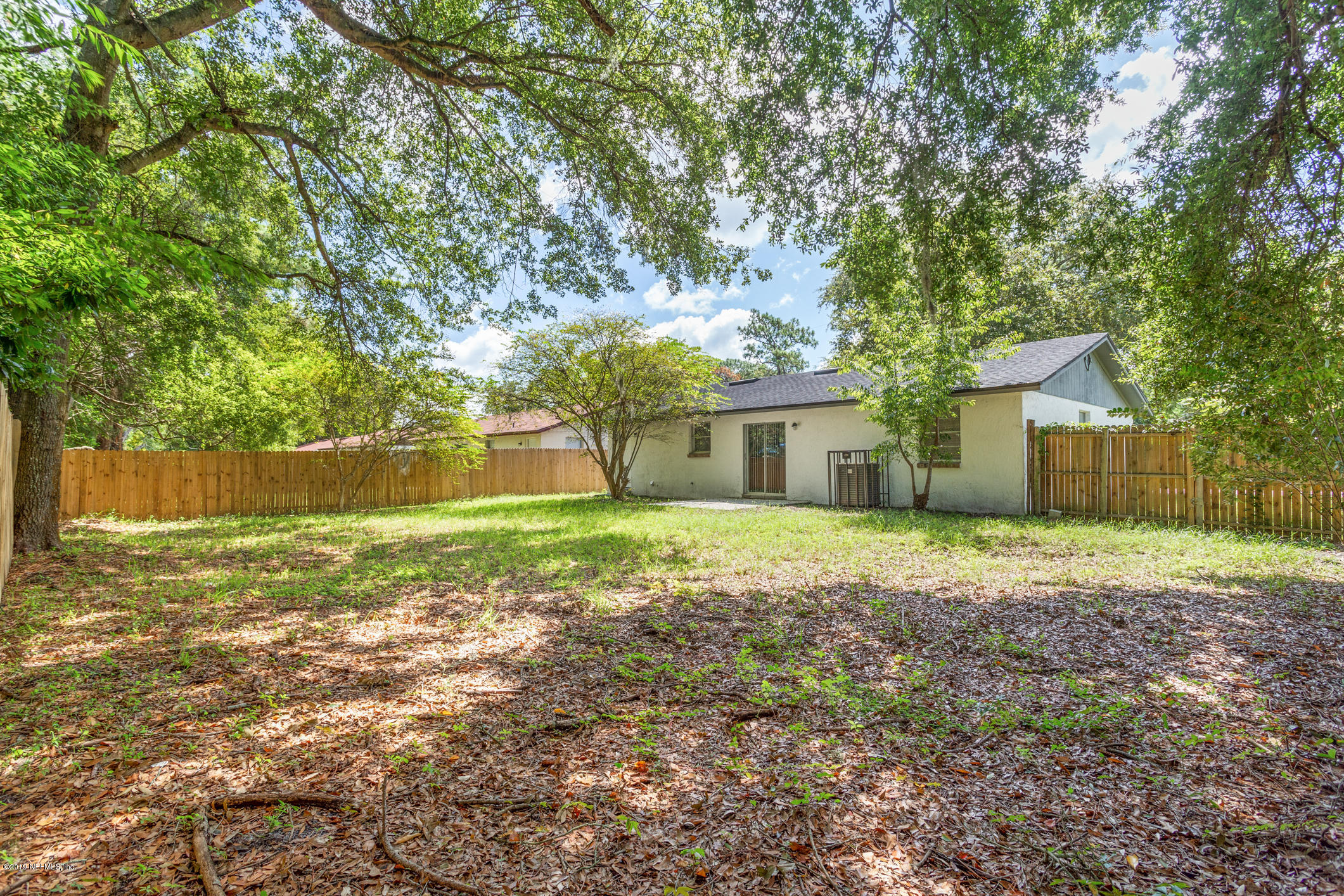 7163 Melvin Road Jacksonville, FL 32210 - Photo 30 of 33 a front view of a house with a yard and trees
