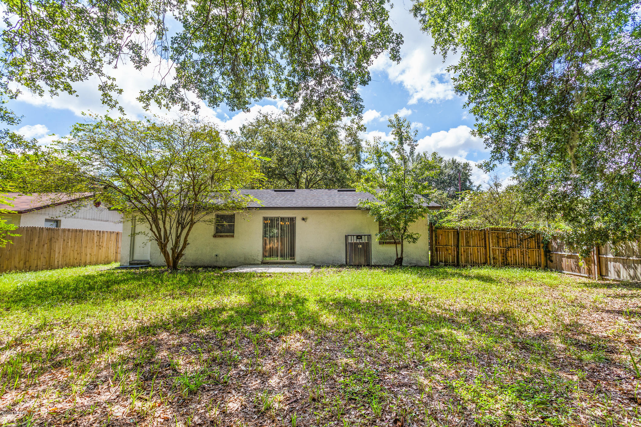 7163 Melvin Road Jacksonville, FL 32210 - Photo 31 of 33 a front view of house with yard and trees