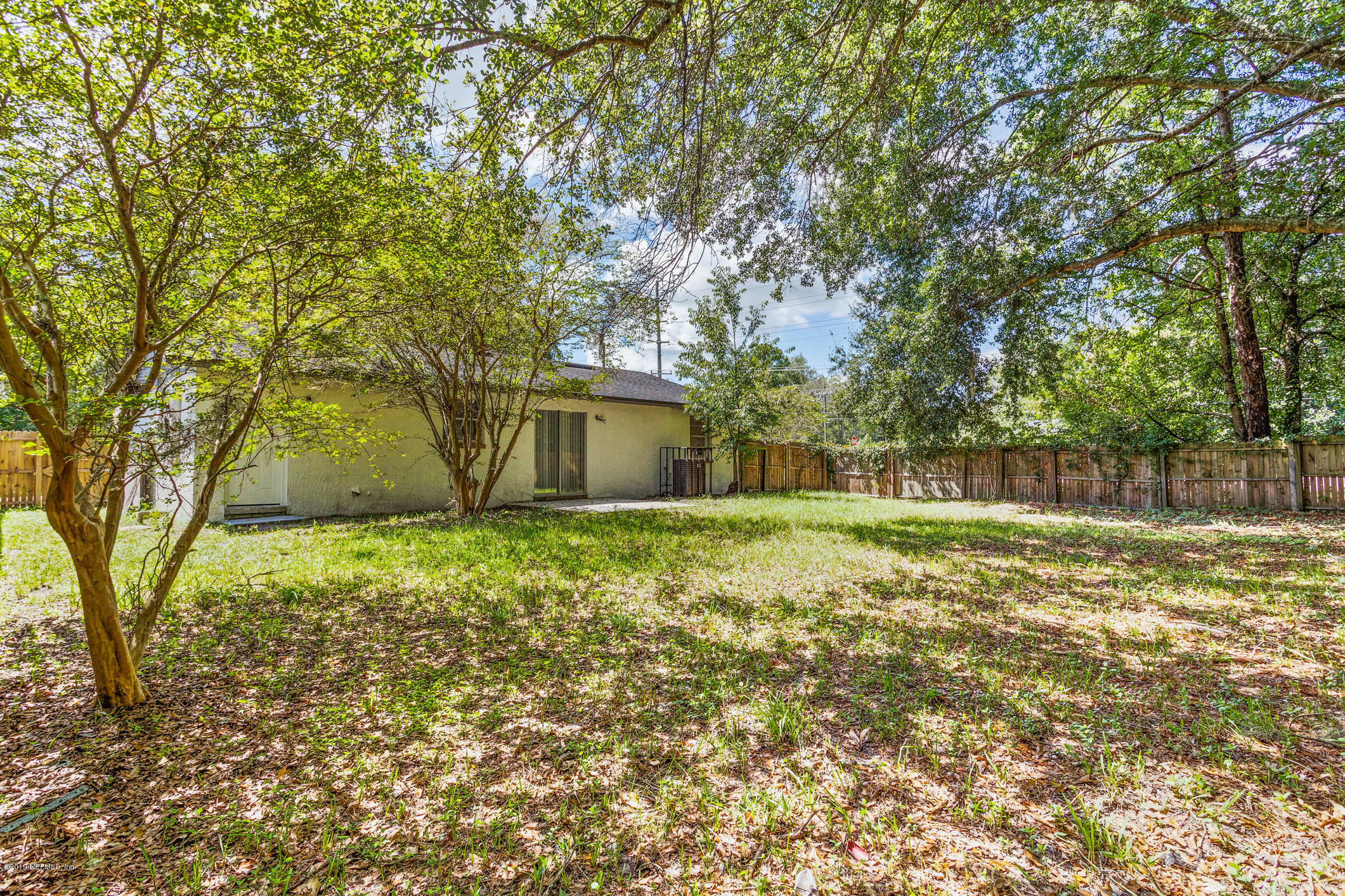 7163 Melvin Road Jacksonville, FL 32210 - Photo 32 of 33 a backyard of a house with lots of green space