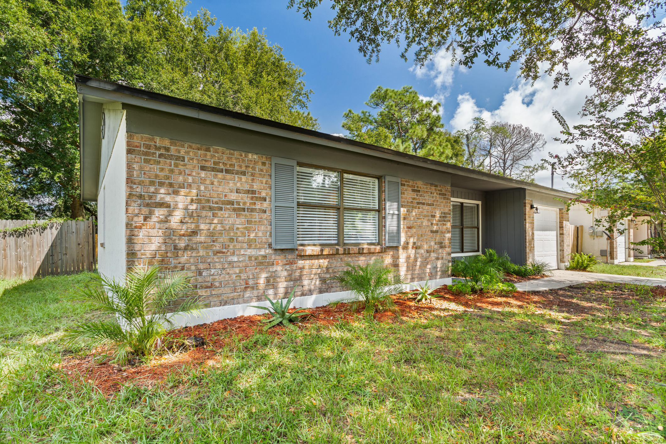 7163 Melvin Road Jacksonville, FL 32210 - Photo 5 of 33 a house view with a garden space