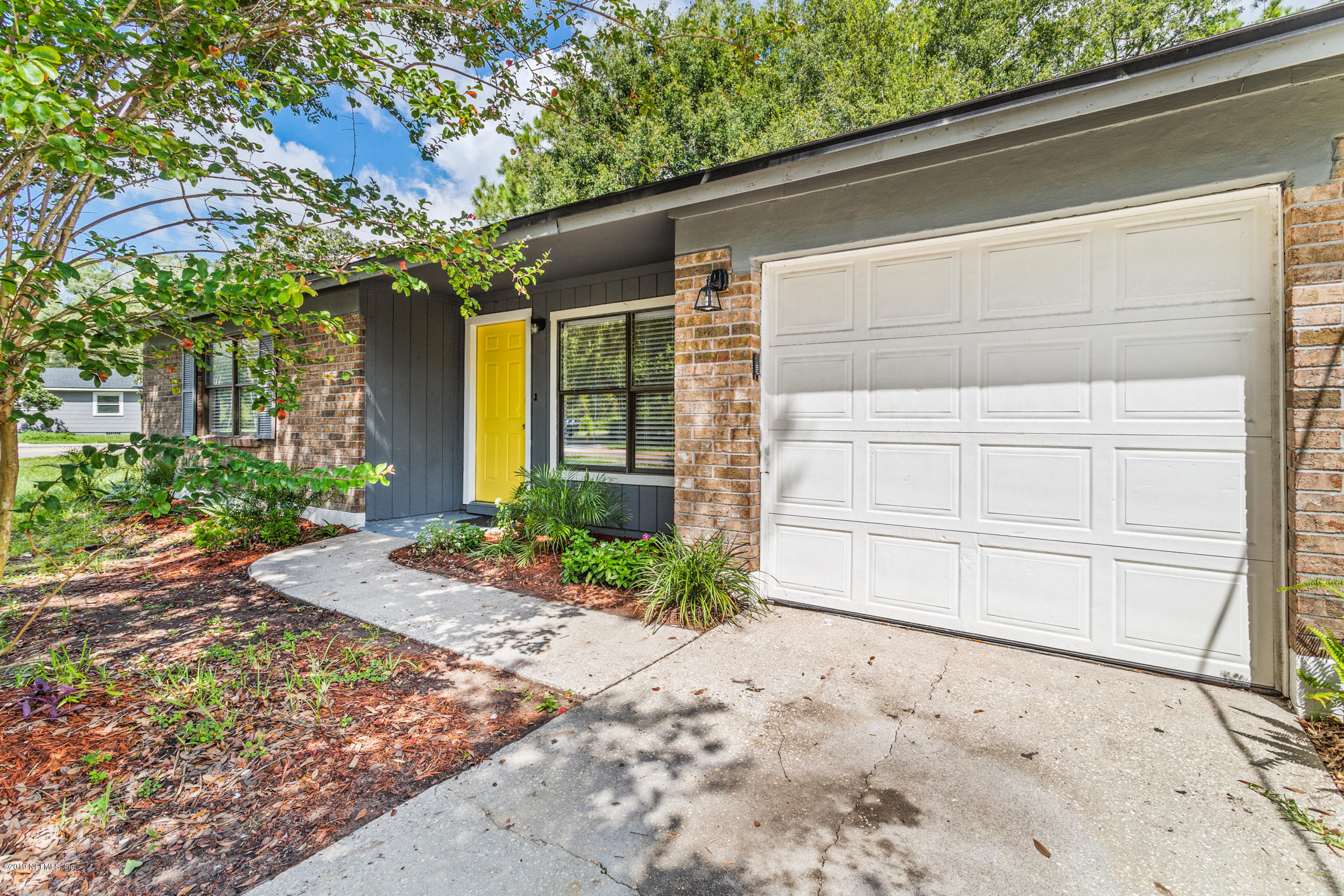 7163 Melvin Road Jacksonville, FL 32210 - Photo 6 of 33 a front view of a house with a yard and garage