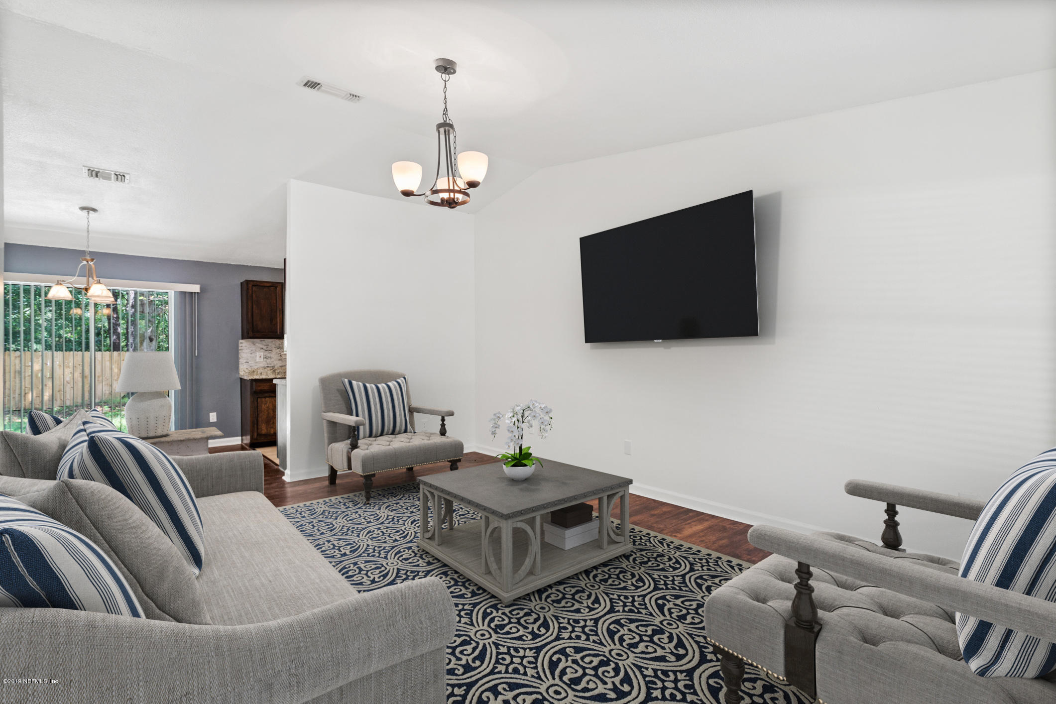 7163 Melvin Road Jacksonville, FL 32210 - Photo 8 of 33 a living room with furniture and a flat screen tv