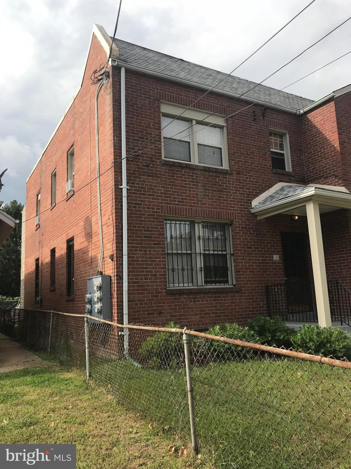 3011 9th Street Southeast Washington, DC 20032 - Photo 3 of 6 a front view of a house with a yard