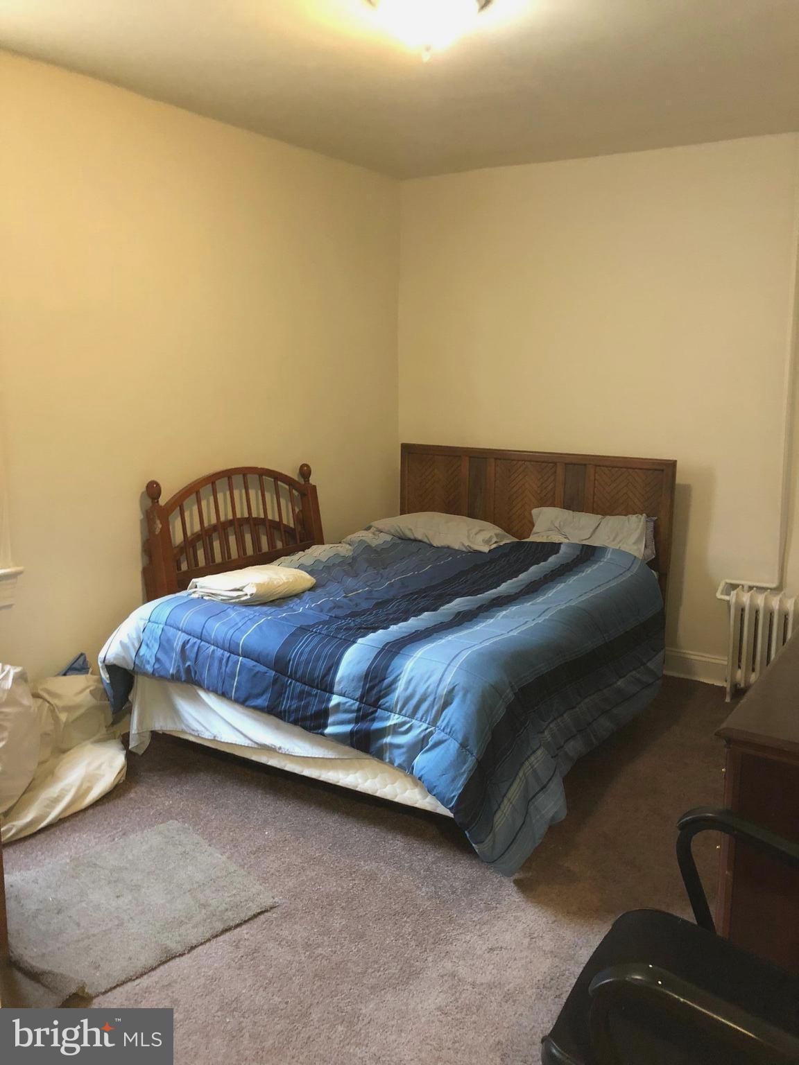 3011 9th Street Southeast Washington, DC 20032 - Photo 4 of 6 a bedroom with a bed and chair