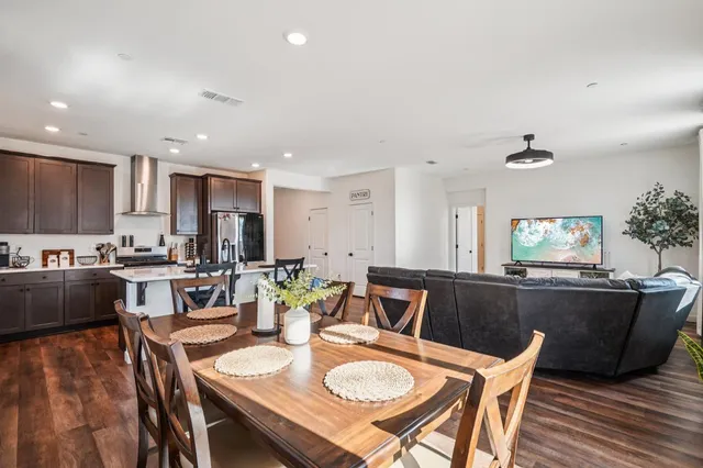 a view of a dining room with furniture and wooden floor