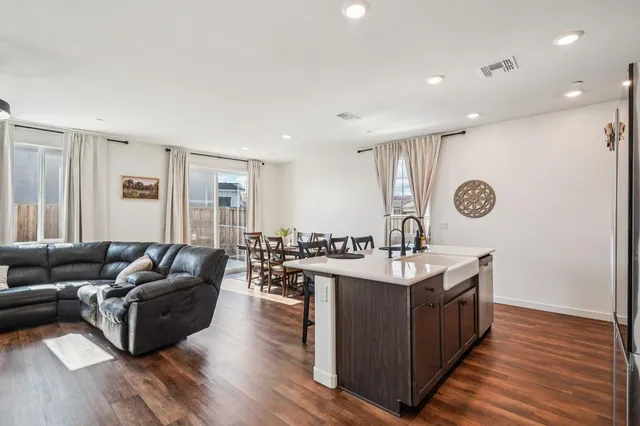 a living room with granite countertop kitchen island furniture and wooden floor