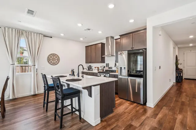 a kitchen with refrigerator and windows
