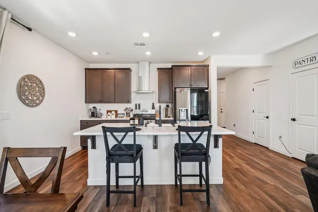 a view of a dining room with furniture and wooden floor