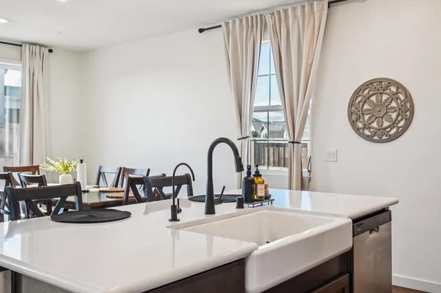 a kitchen with a sink and a table with chairs