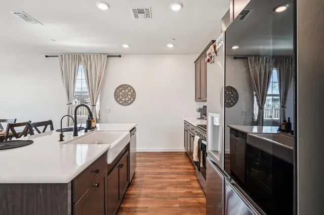 a kitchen with granite countertop a sink stainless steel appliances a counter space and cabinets