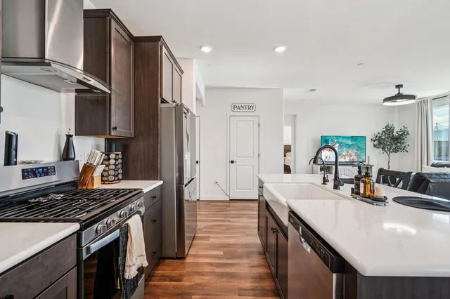 a kitchen with a sink stove and refrigerator