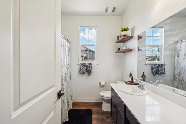 a bathroom with a sink toilet and shower