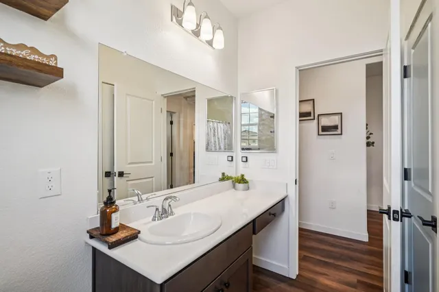 a bathroom with a sink a mirror and a shower