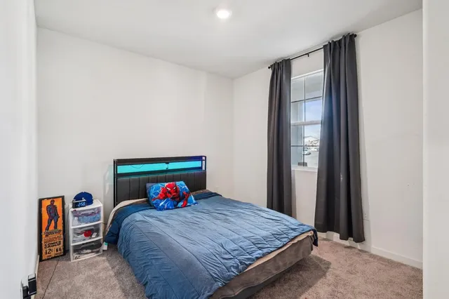 a bedroom with a bed and a potted plant