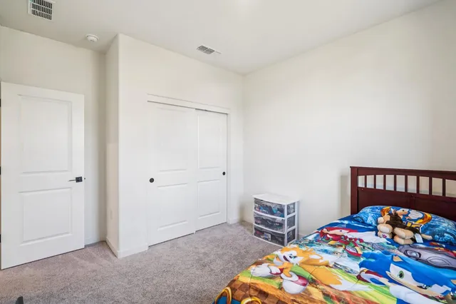 a bedroom with a bed and a dresser in it