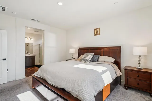 a bedroom with a bed and a lamp