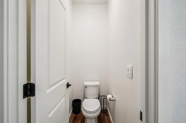 a white toilet sitting next to a shower