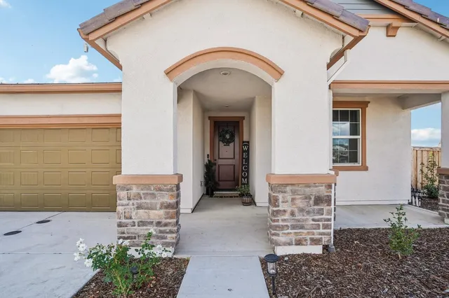 a front view of a house with a garden