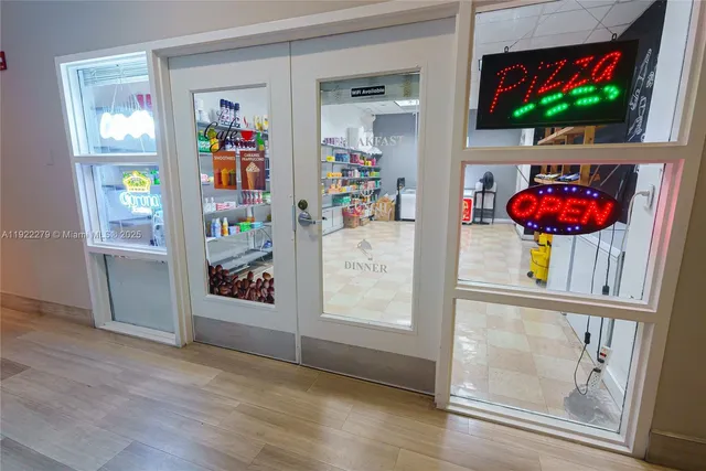 an outdoor living room with furniture and a flat screen tv