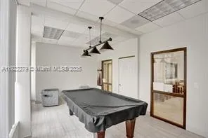 a kitchen with a table chairs and refrigerator