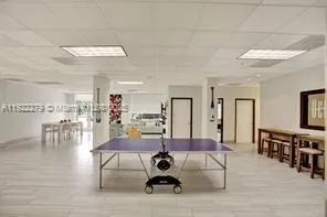 a living room with furniture a wooden floor and next to a window