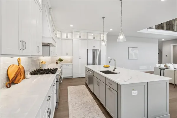 a kitchen with a sink stove and cabinets