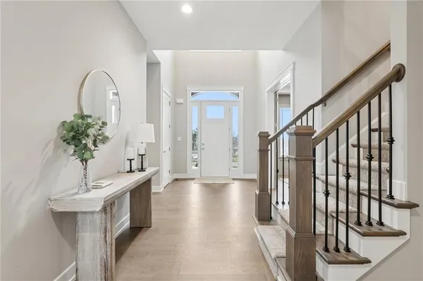 a view of an entryway with wooden floor and stairs