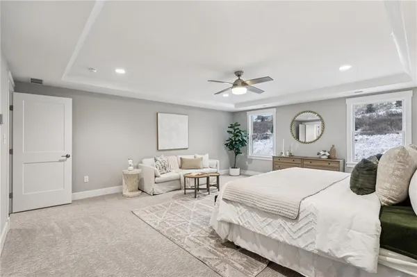 a bedroom with a large bed and chandelier
