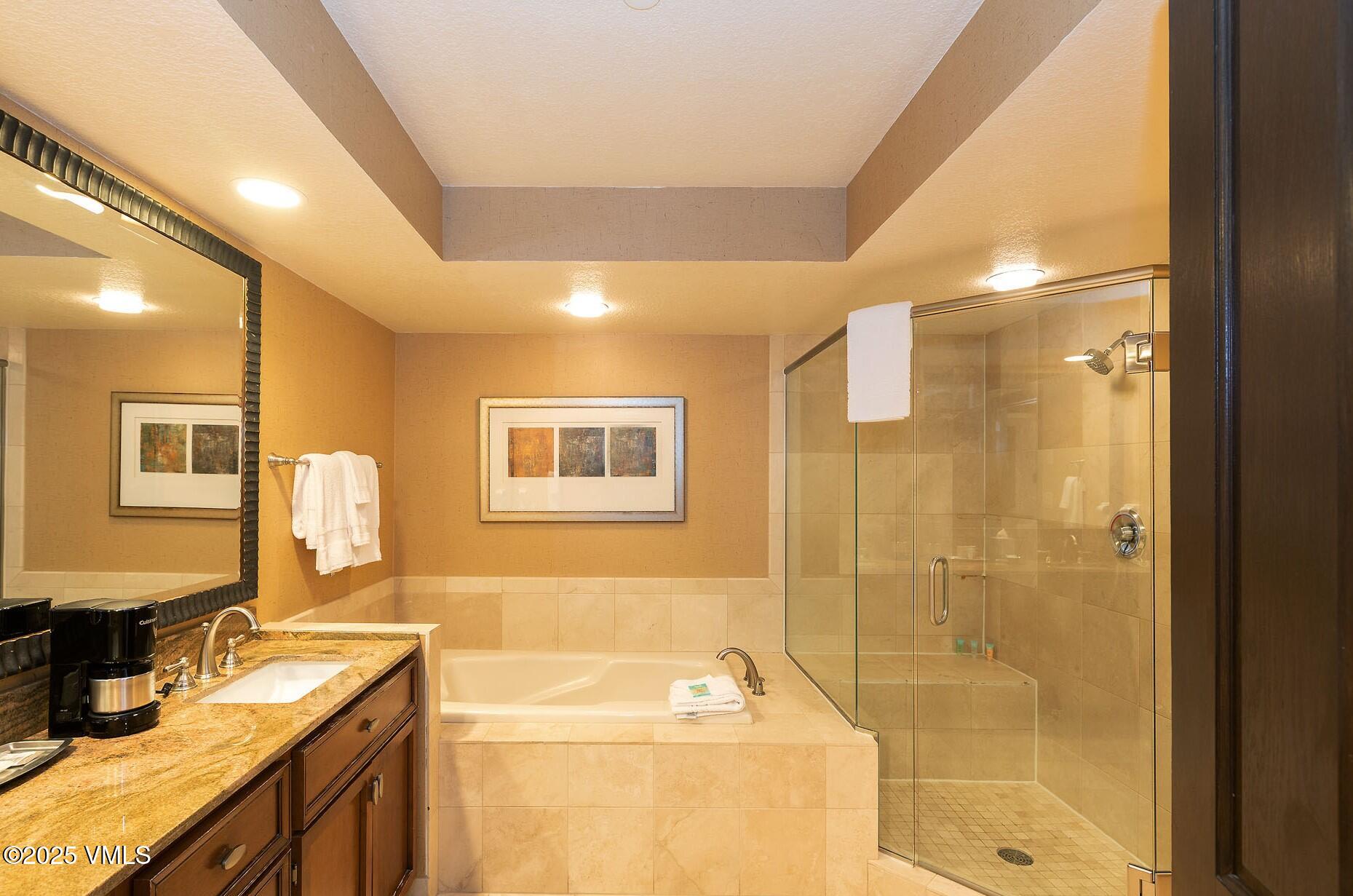 210 Offerson Road, Unit R307 WEEKS 13 & 14 Beaver Creek, CO 81620 - Photo 20 of 26 a bathroom with a granite countertop sink a toilet a mirror and shower